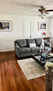 a living room with a couch and a glass table at Hannah House South Cozy country living near the city in Thomaston