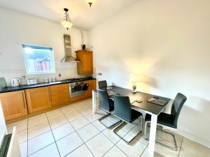 a kitchen with a dining room table and chairs at Spacious & Quiet, a perfect base in Bishops Stortford