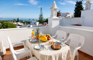 a table with a plate of food on a balcony at Casa Oliveira - Algarve in Porches