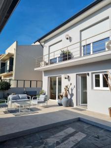 een wit huis met een patio met 2 stoelen bij ON THE WAY - Mindelo Beach/Guest House in Mindelo