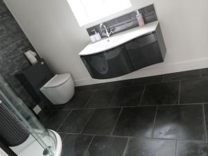 a bathroom with a sink and a toilet at Self contained annexe in Kidderminster