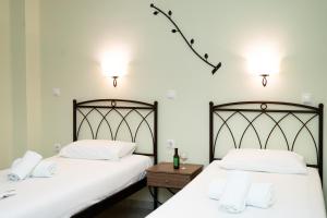 two beds sitting next to each other in a room at Konstantinos Hotel & Apartments 2 in Nydri