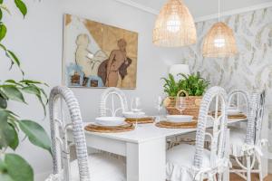 ein weißes Esszimmer mit einem weißen Tisch und Stühlen in der Unterkunft Apartamento excelente ubicación cerca de la playa in Marbella