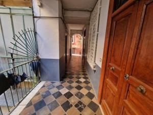 a hallway with a checkered floor in a house at Pastel blue house x 5 people in Corso above metro Montesanto in Naples