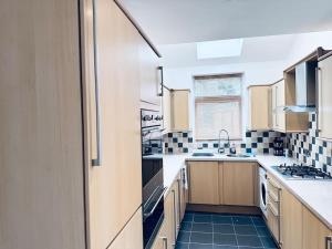 a kitchen with black and white tiles on the floor at Comfy House Near The City Centre in Nottingham