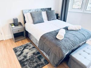 a bedroom with a large bed with two pillows at Comfy House Near The City Centre in Nottingham