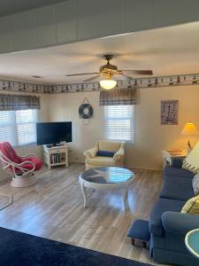 a living room with a couch and a table at Beach Breeze 1, short walk to Atlantic Ocean, pet friendly, very quiet & family friendly in Myrtle Beach