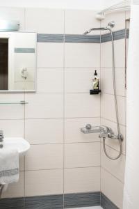 a bathroom with a shower and a sink at Konstantinos Hotel & Apartments 2 in Nydri