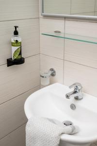 a bathroom with a white sink and a mirror at Konstantinos Hotel & Apartments 2 in Nydri