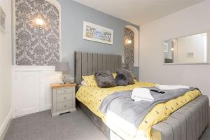 a bedroom with a bed with two stuffed animals on it at Rame in Looe