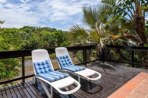 two chairs sitting on top of a deck at San Lameer Villa 3108 - 4 Bedroom Classic - 8 pax - San Lameer Rental Agency in Southbroom