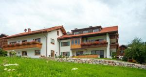 a large house with two balconies on a hill at Panoramablick Heimen in Hopferau