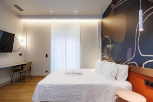a hotel room with a bed and a desk at K2 Suites Kalamata in Kalamata