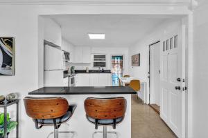 a kitchen with a counter and two bar stools at 3 Bedroom Villa In F Lauderdale Casino & Beach in Fort Lauderdale