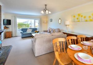 a living room with a couch and a table and chairs at Mor Gragen in Abersoch