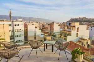 a balcony with chairs and a view of a city at Mosaics Athens Boutique Apartments in Athens