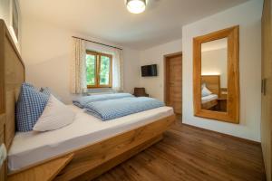 a bedroom with a large bed with a mirror at Panoramablick Heimen in Hopferau