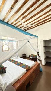 a bedroom with two beds in a room at Cozy Lodge - Guesthouse in Jambiani