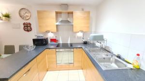 a kitchen with a sink and a counter top at Contemporary One-Bedroom Apartment in Sheffield City Centre in Sheffield