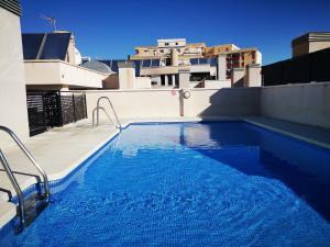 a swimming pool on the roof of a building at Apartamento Cervantes in Málaga