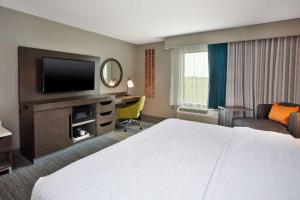 a hotel room with a bed and a flat screen tv at Hampton Inn Union City, Tn in Union City