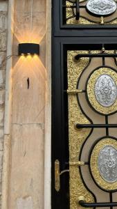 une porte menant à un bâtiment doré et noir dans l'établissement سويت هوم بتصاميم حديثة ودخول ذكي, à Haïl