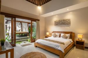 a bedroom with a bed and a large window at Villa Lapiz Lazuli - Seminyak Kuta Luxury Private Pool Villas in Seminyak +77 photos