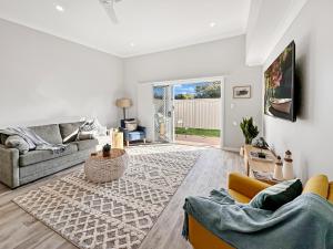 a living room with a couch and a table at Family-friendly Seaside Gem in Urangan
