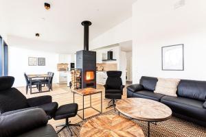 a living room with a couch and a fireplace at Villa Karina - Beachfront with Jacuzzi in Porvoo