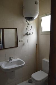 a bathroom with a sink and a toilet and a window at f- ground floor with garden in Hurghada