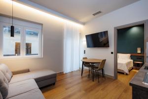 a living room with a couch and a table at K2 Suites Kalamata in Kalamata