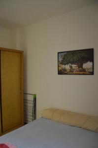 a bedroom with a bed and a painting on the wall at f- ground floor with garden in Hurghada