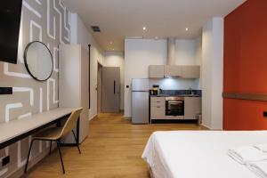 a small room with a bed and a kitchen at K2 Suites Kalamata in Kalamata