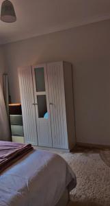 a bedroom with a bed and a cabinet with a mirror at العليا in Al Khobar