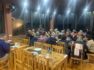 a group of people sitting at tables in a room at Ngan Nga Legend in Bắc Hà