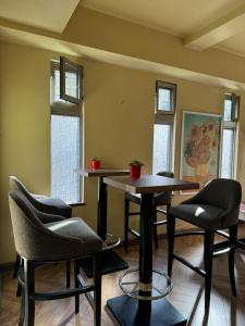 a room with two tables and chairs and windows at PAThouse台东Asakusa店 in Tokyo