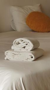 a white towel sitting on top of a bed at Macrisbete 2 in Fátima