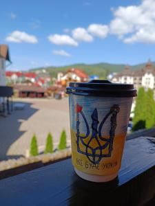 a cup of coffee sitting on top of a table at Villa Morishka & SPA in Bukovel