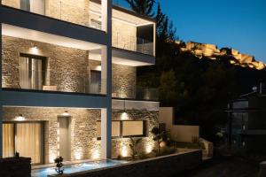 a building with lights on the side of it at Fildisi luxury suites in Nafplio