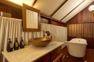 a bathroom with a bowl sink and a toilet at Jambolan Chiangmai in Chiang Mai