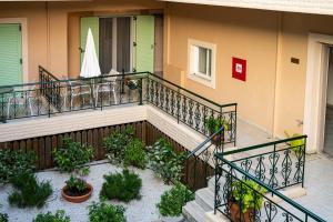 a balcony of a house with plants on it at Konstantinos Hotel & Apartments 2 in Nydri
