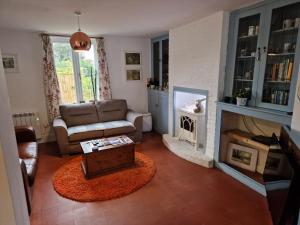 Lily Cottage In Idyllic Reedham في Reedham: غرفة معيشة مع أريكة ومدفأة