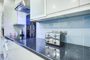 a kitchen with a toaster on a counter at CrossVille Homes - Double rooms in Navestock