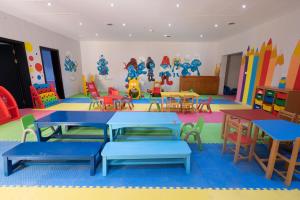 a classroom with tables and chairs in a play room at Parrotel Lagoon Waterpark Resort in Sharm El Sheikh
