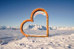 a heart in the snow with a mountain in the background at Bio Bauernhof Vorderoberlehen in Werfenweng