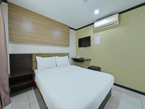 Postel nebo postele na pokoji v ubytování One Enigma Hotel