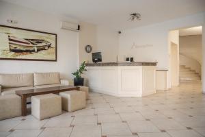 a living room with a couch and a table at Konstantinos Hotel & Apartments 2 in Nydri