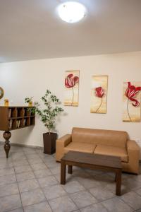 a living room with a couch and paintings on the wall at Konstantinos Hotel & Apartments 2 in Nydri
