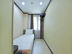 Postel nebo postele na pokoji v ubytování One Enigma Hotel