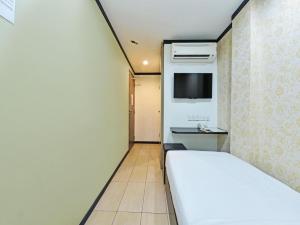 Postel nebo postele na pokoji v ubytování One Enigma Hotel